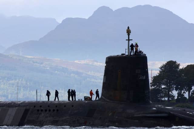 A Vanguard-class nuclear-powered submarine sails from HMNB Faslane on the Firth of Clyde. The UK is committed to replacing its continuous at sea deterrent in the future