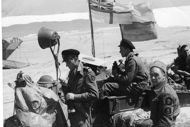 RN Commandos (right) on the beach near Courseulles in June 1944. PIC:  US National Archives and Record Administration.