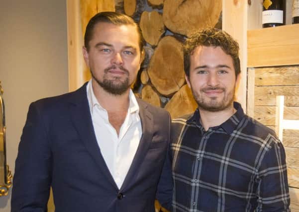 Leonardo DiCaprio poses with social entrepreneur Josh Littlejohn at Social Bite restaurant, during his visit to Edinburgh