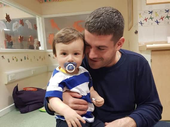 Alfie with his dad in hospital.