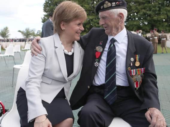 First Minister Nicola Sturgeon sits with D-Day veteran John Greig, 95, from Dumfries, at the Commonwealth War Graves Commission Cemtery in Bayeaux, France, ahead of commemorations for the 75th anniversary of the D-Day landings.