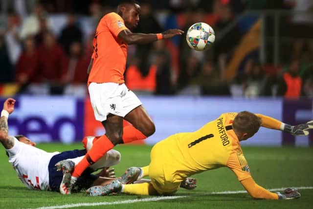Quincy Promes shot deflects off Englands Kyle Walker (left) and leads to the Netherlands decisive second goal. Picture: PA.