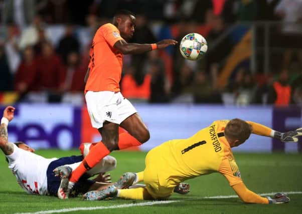 Quincy Promes shot deflects off Englands Kyle Walker (left) and leads to the Netherlands decisive second goal. Picture: PA.