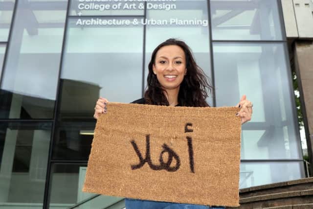 A Scottish art student - Zara Elmi - is designing a range of welcome signature door mats for refugees being housed in Scotland
. The mat says welcome in Arabic