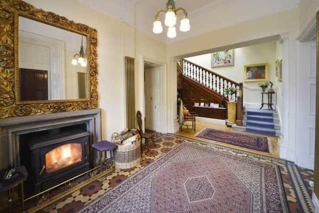 The grand hallway has a large wood burning stove.