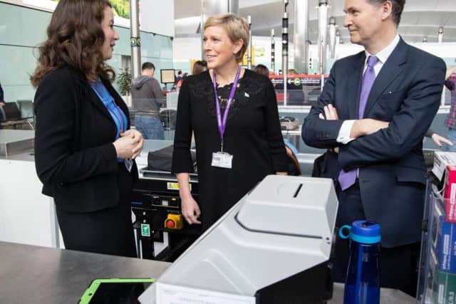UK aviation minister Baroness Vere (centre) with a Heathrow Airport staff member and chief executive John Holland-Kaye beside a new CT scanner. Picture: Heathrow Airport