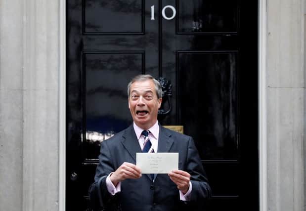 Brexit Party leader Nigel Farage holds a letter addressed to Britain's Prime Minister Theresa May as he arrives to deliver it to 10 Downing Street. Picture: TOLGA AKMEN/AFP/Getty Images