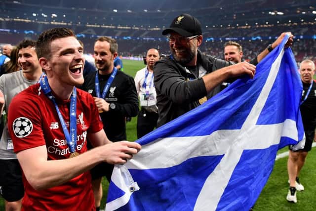 Andy Robertson parades the Saltire with manager Jurgen Klopp in Madrid after lifting the Champions League trophy with Liverpool. Picture: Andrew Powell/Liverpool FC via Getty