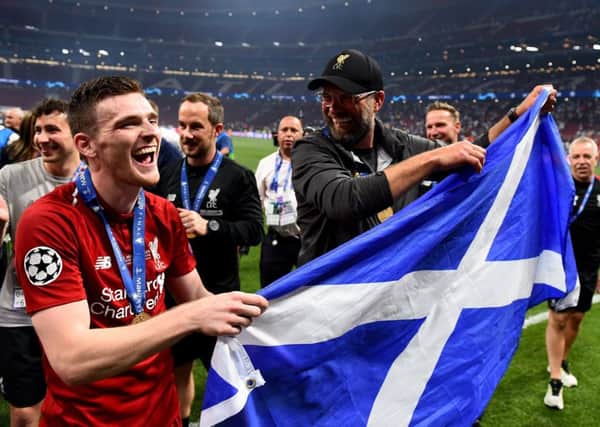 Andy Robertson parades the Saltire with manager Jurgen Klopp in Madrid after lifting the Champions League trophy with Liverpool. Picture: Andrew Powell/Liverpool FC via Getty