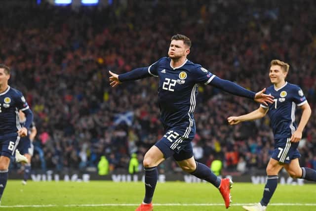 Oli Burke wheels away after netting the winner for Scotland