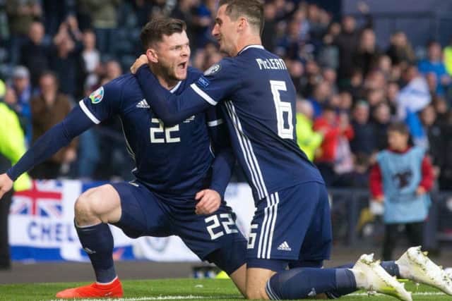 Oliver Burke celebrates his goal with Kenny McLean