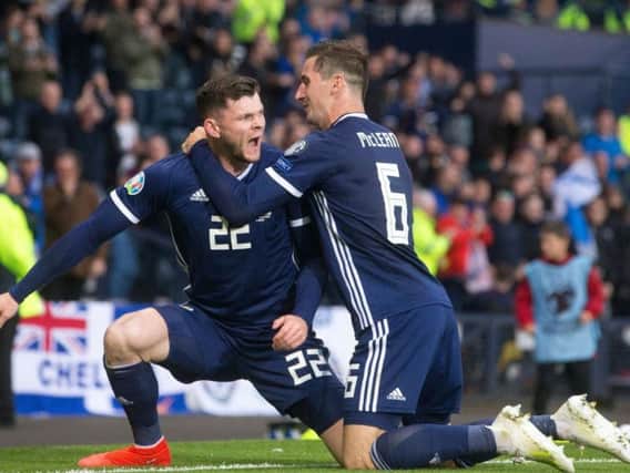 Oliver Burke celebrates his goal with Kenny McLean