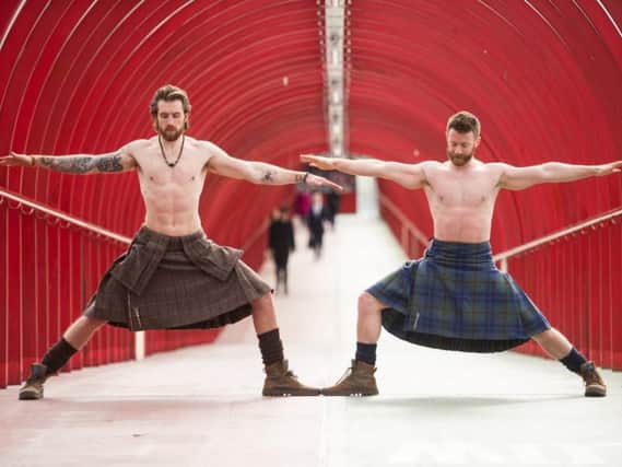 Finlay Wilson (right) and Tristan Cameron-Harper show off their yoga skills in Glasgow. Picture: John Devlin