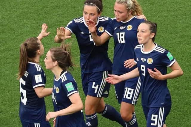 Claire Emslie is congratulated by her team mates after scoring Scotland's goal on Sunday.