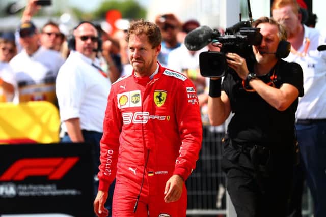 Sebastian Vettal storms into parc fermé to swap the first and second place boards on the cars. Picture: Dan Istitene/Getty