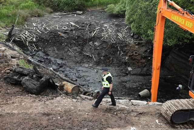 A Police officer walks past the emptied Leanach Quarry near Leanach quarry was previously deemed too dangerous to use divers but police are extremely confident that vital evidence will be found. Picture:  Andrew Milligan/PA Wire