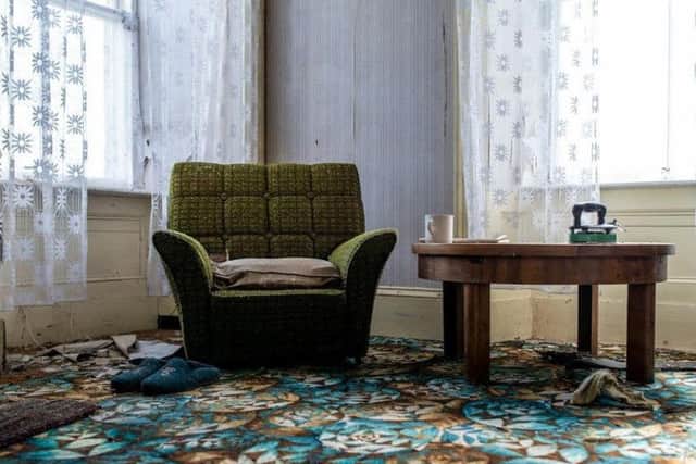 A pair of slippers still sit next to an armchair in this house, which is thought to have been left behind around 20 to 30 years ago. PIC: The Cabrach Trust.