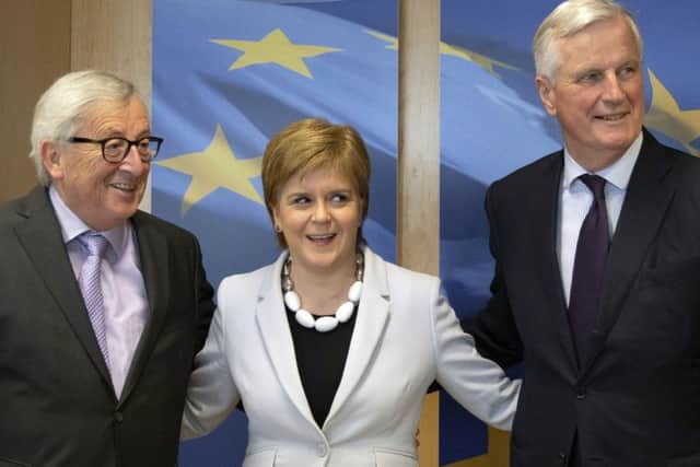 First Minister Nicola Sturgeon with European Commission President Jean-Claude Juncker, left, and European Union chief Brexit negotiator Michel Barnier. Picture: AP Photo/Virginia Mayo