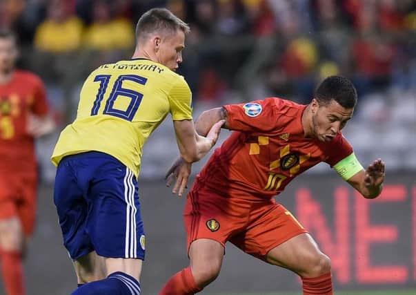 Scotland midfielder Scott McTominay vies for possession with Belgiums Eden Hazard. Picture: John Thys/AFP/Getty Images