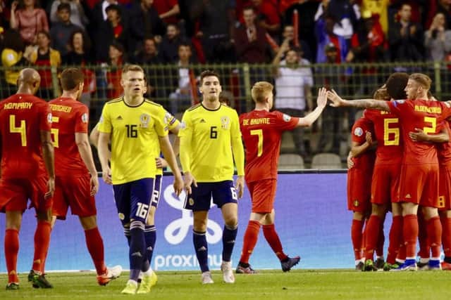 Dejection for Scott McTominay and Kenny McLean as Belgium celebrate scoring their second goal