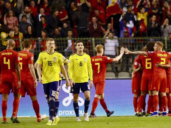Dejection for Scott McTominay and Kenny McLean as Belgium celebrate scoring their second goal