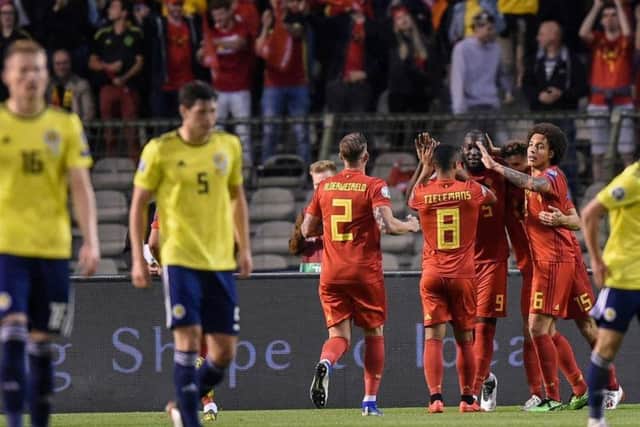 Brussels pouts: Belgium celebrate Romelu Lukaku's opener as Scott McTominay and Scott McKenna look dejected