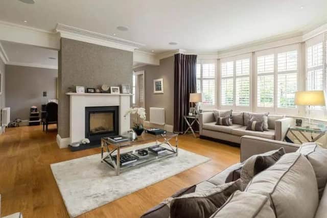 The living room has a feature fireplace, behind which the dining room can be found.