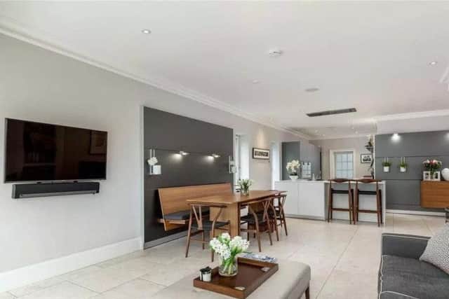 The open-plan kitchen has a family room and TV.