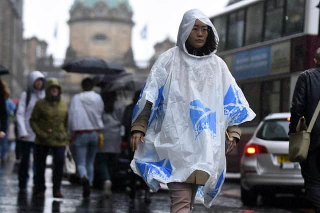 Tourists feeling the impact of rain in Edinburgh. Picture: Lisa Ferguson