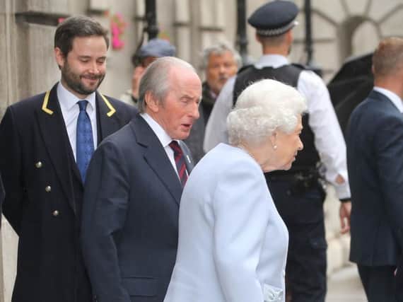 Sir Jackie Stewart was pictured escorting the Queen to her car. Picture: PA
