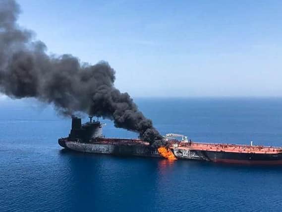 Fire and smoke billows from a Norwegian-owned oil tanker reportedly attacked near the Persian Gulf