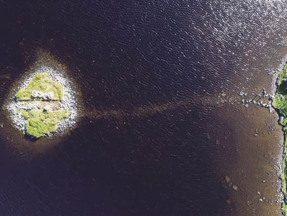 An aerial view of the crannog at Loch Bhorgastail, which shows the stone causeway leading to the site. PIC: Fraser Sturt.