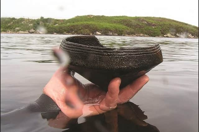 A piece of Neolithic pottery pulled from the bed of of one of the lochs by diver Chris Murray, who lives on the Isle of Lewis.
