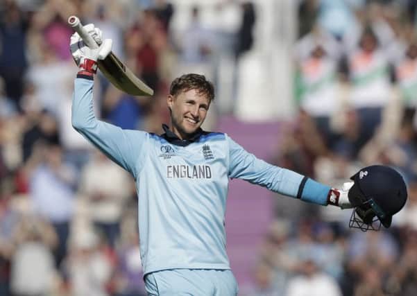 Joe Root celebrates reaching his second century of the tournament as England eased to an eight-wicket victory over the West Indies. Picture: AP.