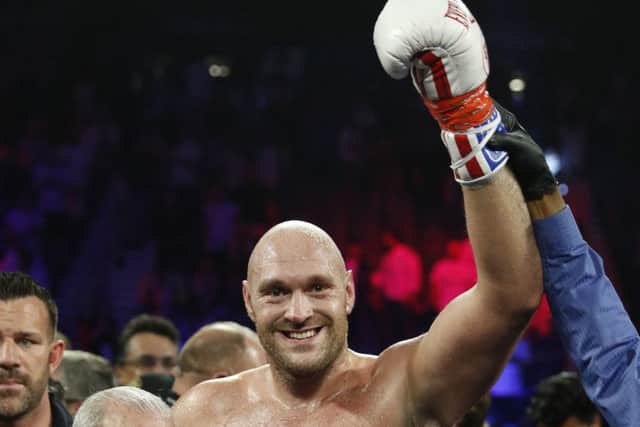 Tyson Fury poses for photographers after defeating Tom Schwarz, of Germany. Picture: AP.