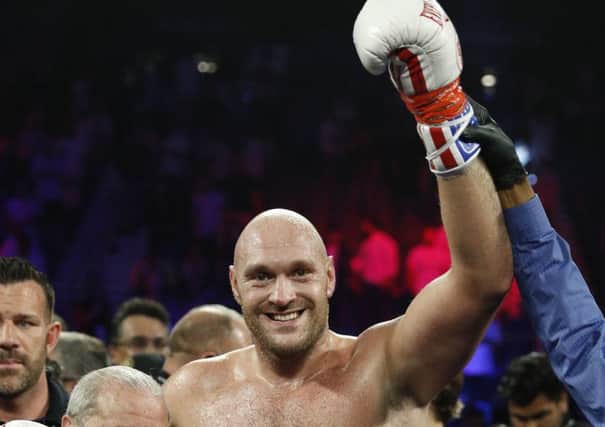 Tyson Fury poses for photographers after defeating Tom Schwarz, of Germany. Picture: AP.