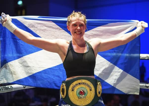 Hannah Rankin with the Saltire and the precious belt she won in Paisley on Saturday. Picture: SNS.