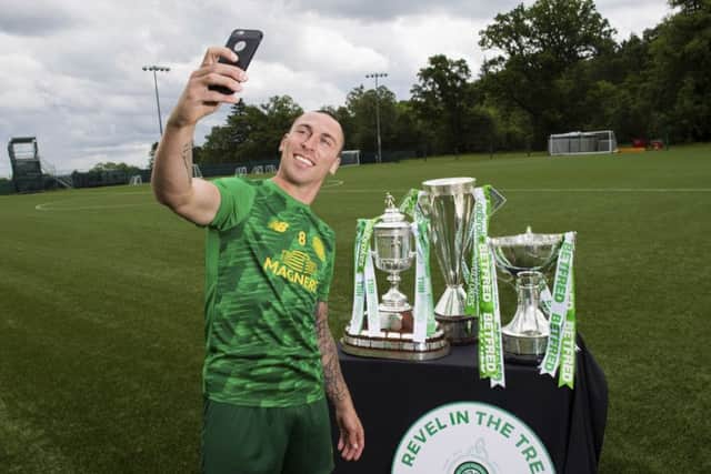 Celtic captain Scott Brown celebrated the club's historic treble treble. Picture: Paul Devlin/SNS