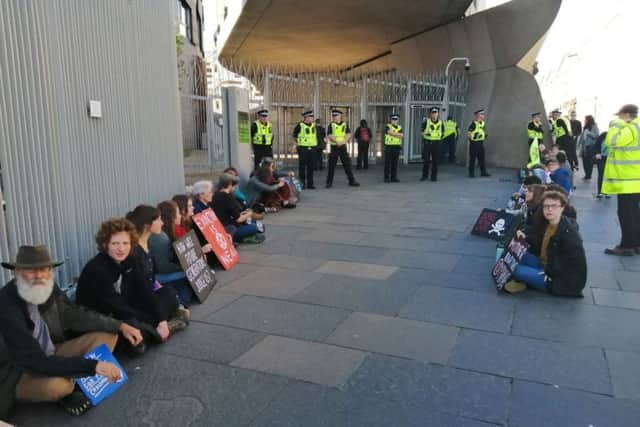 Extinction Rebellion protestors glued themselves to sites around the Parliament building at Holyrood
