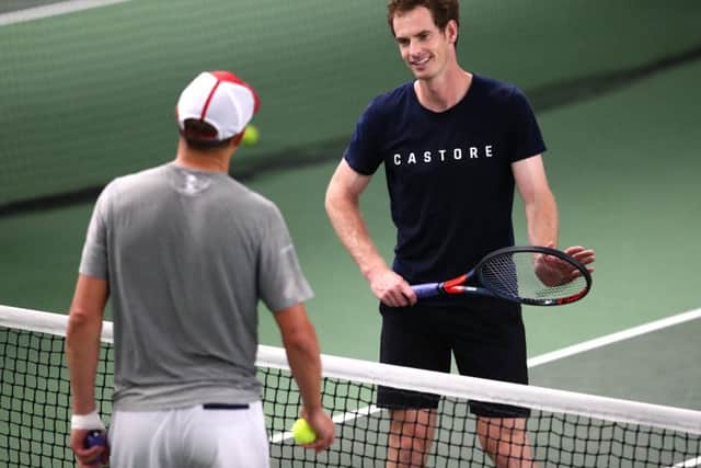 Andy Murray speaks with Bob Bryan during a practice session at Queen's Club. Picture: Clive Brunskill/Getty