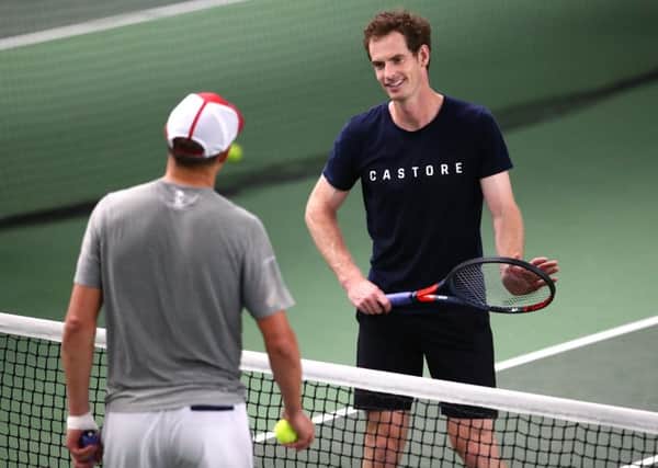 Andy Murray speaks with Bob Bryan during a practice session at Queen's Club. Picture: Clive Brunskill/Getty