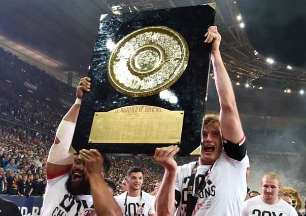 Richie Gray, right, hoists aloft the Bouclier de Brennus trophy after helping Toulouse win the French Top 14 final. Picture: AFP/Getty Images