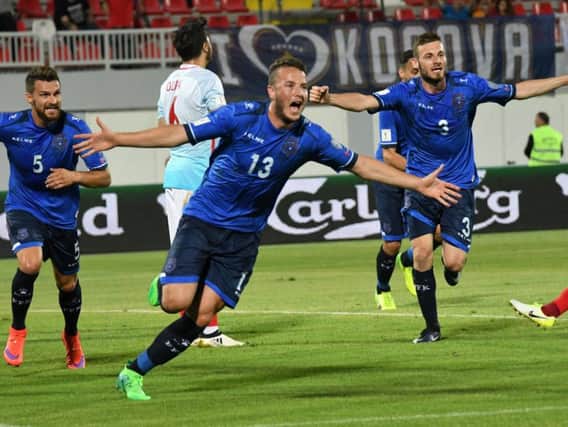 Amir Rrahmani celebrates a goal for Kosovo