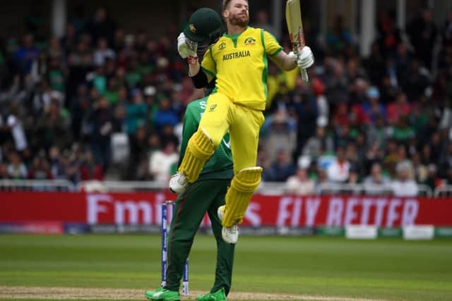 David Warner celebrates reaching his century on the way to 166 during Australias victory over Bangladesh at Trent Bridge yesterday. Picture: AFP/Getty