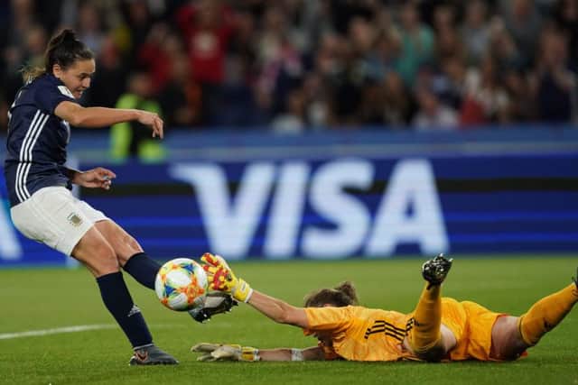 Scotland keeper Lee Alexander makes a heroic block to keep out Florencia Bonsegundos attempt on the rebound but it was in vain as the original penalty was ordered to be retaken after a VAR review. Picture: AFP/Getty