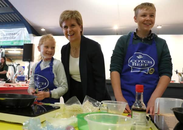 First Minister Nicola Sturgeon met Zara Ross and Fergus Mason at cookery demonstration at the the Royal Highland Show yesterday as she launched a food education programme for young people. Picture: PA