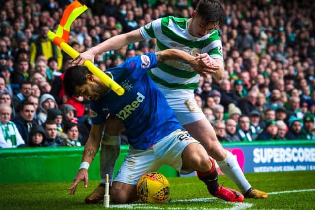 Daniel Candeias battles Kieran Tierney during an Old Firm clash at Celtic Park.