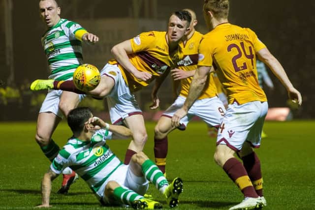 David Turnbull, centre, in action last season for Motherwell against Celtic, who have now signed the midfielder in a £3.25 million deal. Picture: Bill Murray/SNS