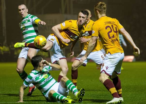 David Turnbull, centre, in action last season for Motherwell against Celtic, who have now signed the midfielder in a £3.25 million deal. Picture: Bill Murray/SNS