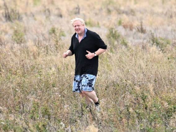 Boris Johnson goes for a jog in what was interpreted as a sly dig at Theresa May's 'field of wheat' anecdote